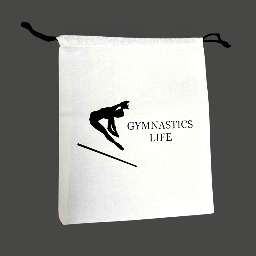 cream colored grip bag with gymnastics life and gymnast in black.  DRYbands best wristbands for gymnasts